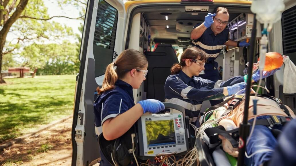 Student paramedics provide medical assistance to a patient inside an ambulance simulator at UniSQ Ipswich.