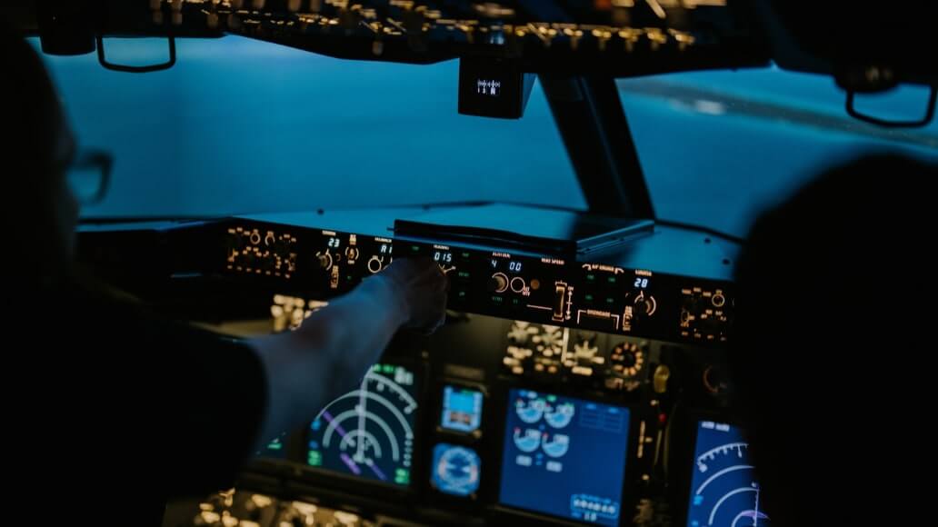 People in an air craft flight simulator.