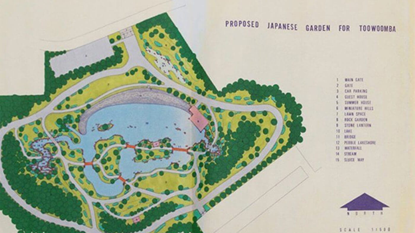 Map of proposed Japanese garden for Toowoomba, featuring labeled elements such as a main gate, gift house, tea house, lake, rock garden, and pathways, surrounded by greenery and water features.