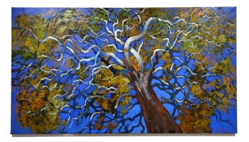A painting depicts a tree with a twisting trunk and branches against a vibrant blue background. The foliage is rendered in shades of green, yellow, and orange.