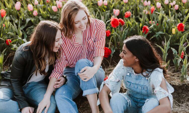 three ladies sitting and laughing