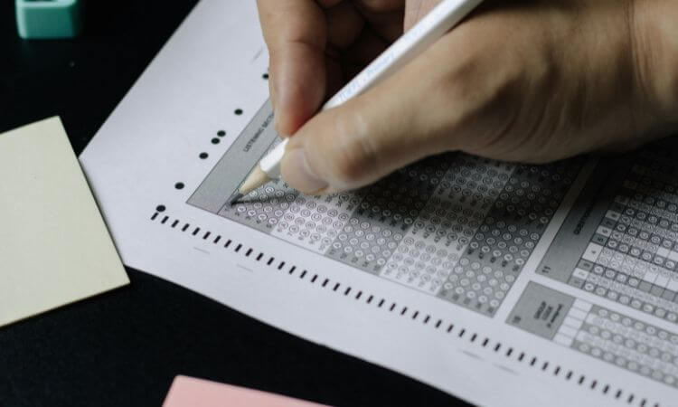 A person is writing on a piece of paper.