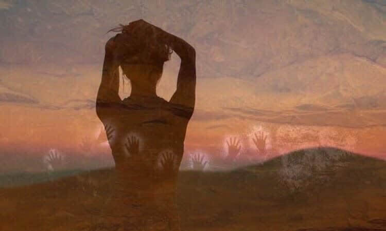 Silhouette of a person with hands on head is overlaid with handprints against a sunset landscape.