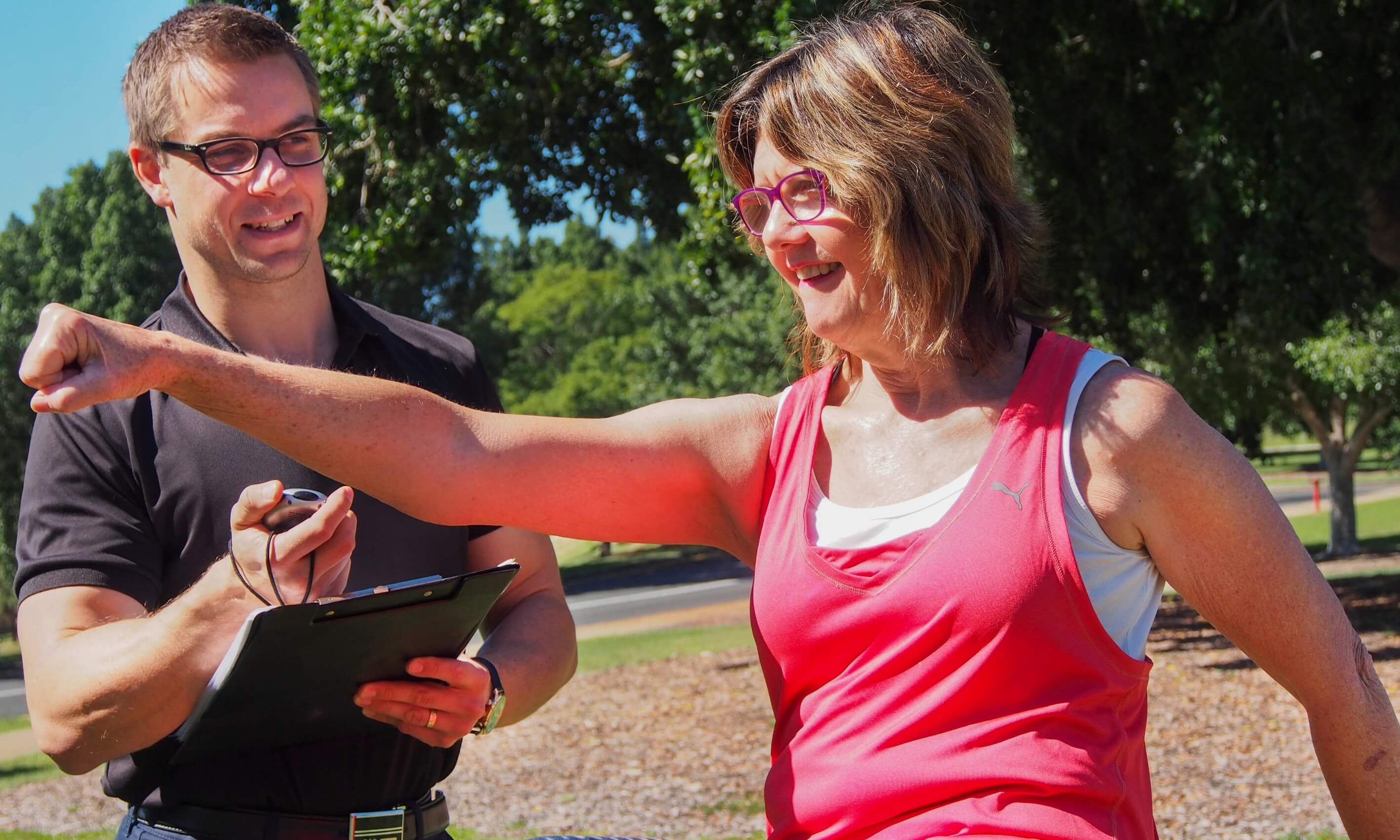 a man instructing a woman on her exercise